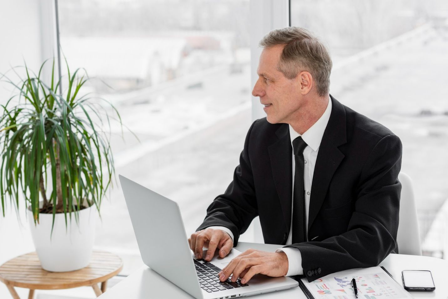 A person in a suit and tie working on a computerAI-generated content may be incorrect.