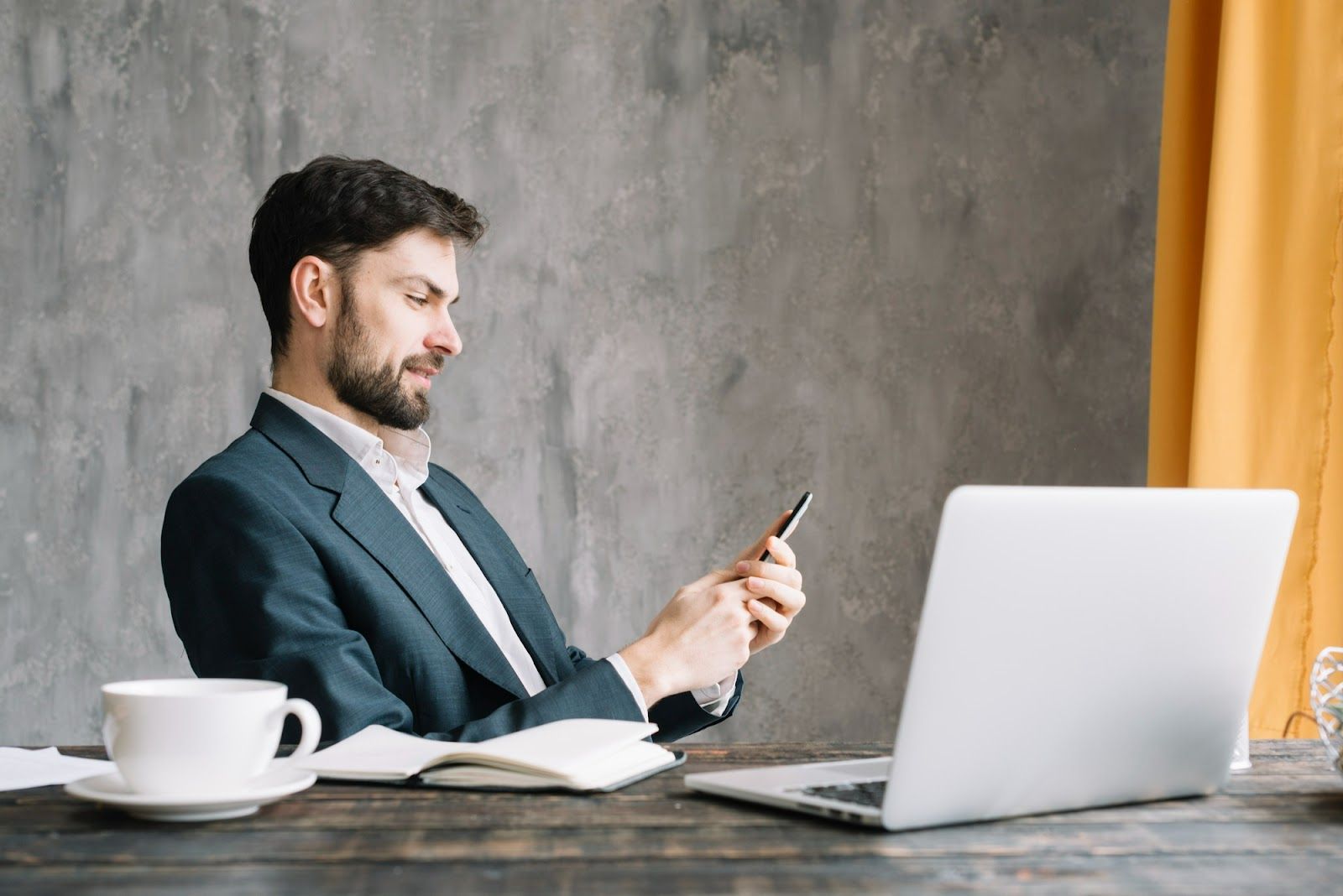 A person sitting at a desk with a computer and a phoneAI-generated content may be incorrect.